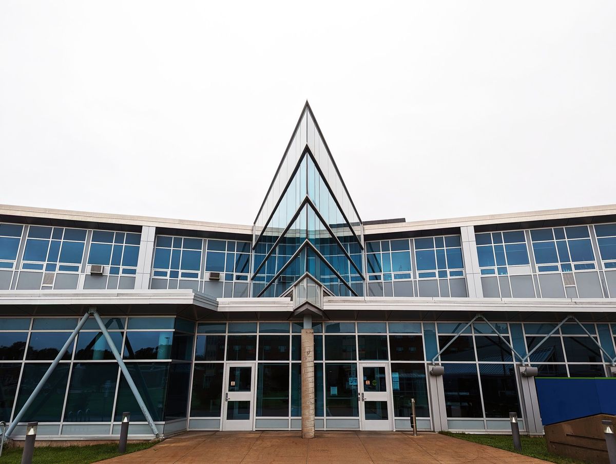 Commercial building entrance with aluminium-framed glazing and glass double doors