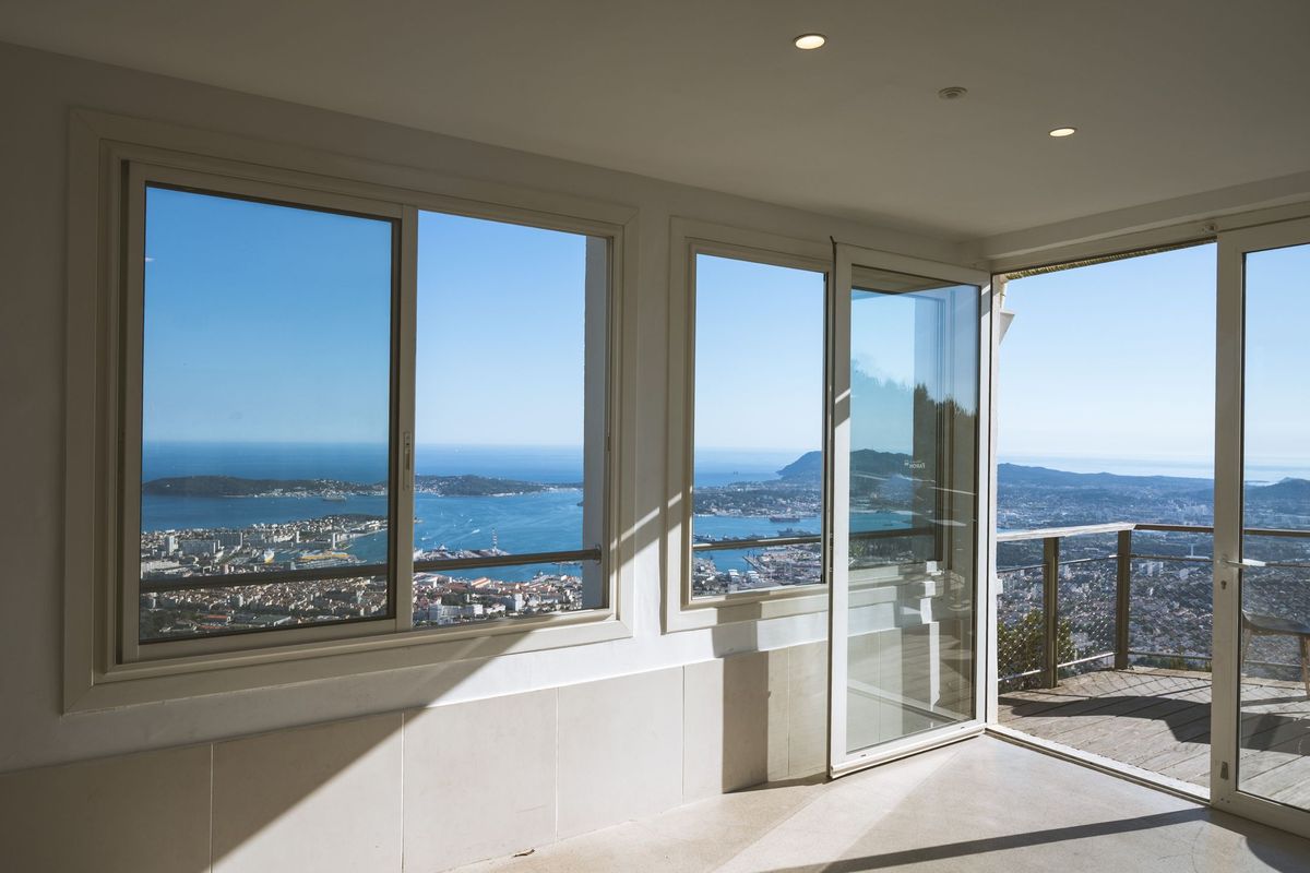 Corner windows and a sliding door looking out over the sea